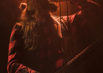 long-hair-guitar-guy-singing-low-view-scaled